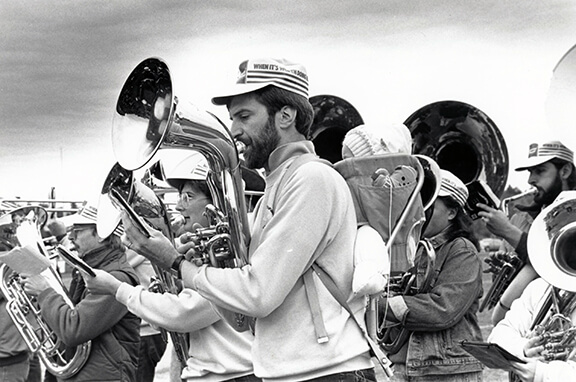 A baby rides on Dad’s back in the Alumni Band parade, circa 1988
