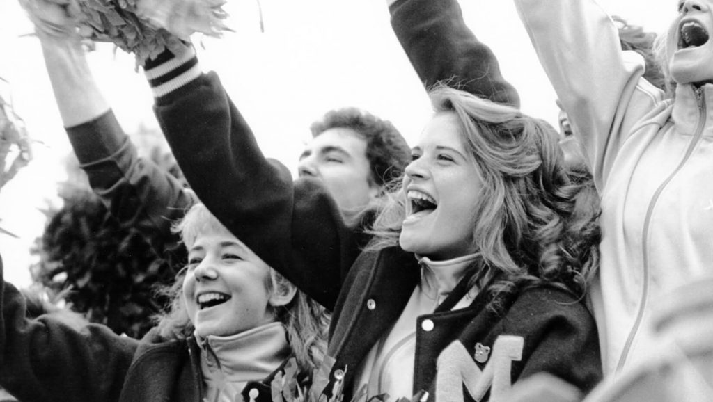 Students cheering at a football game