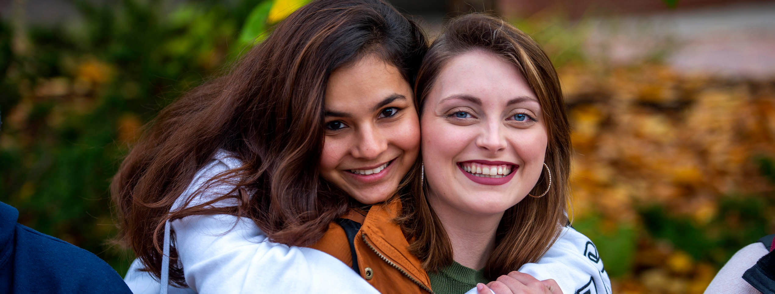 A photo of two students smiling at the camera