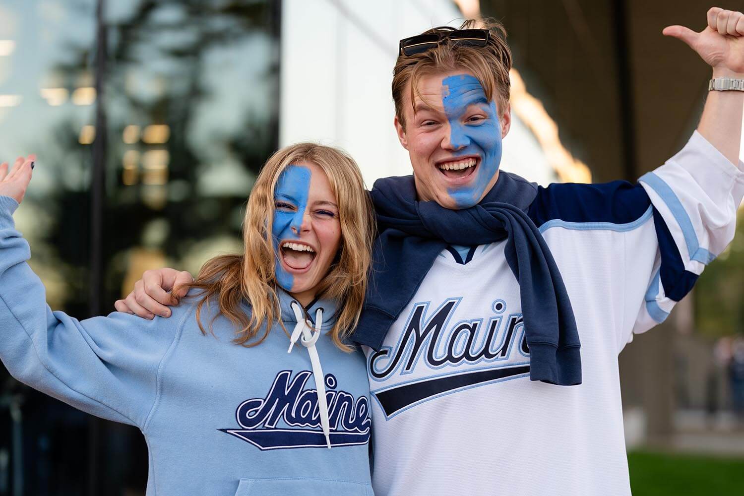 A photo of two hockey fans dressed up for a game
