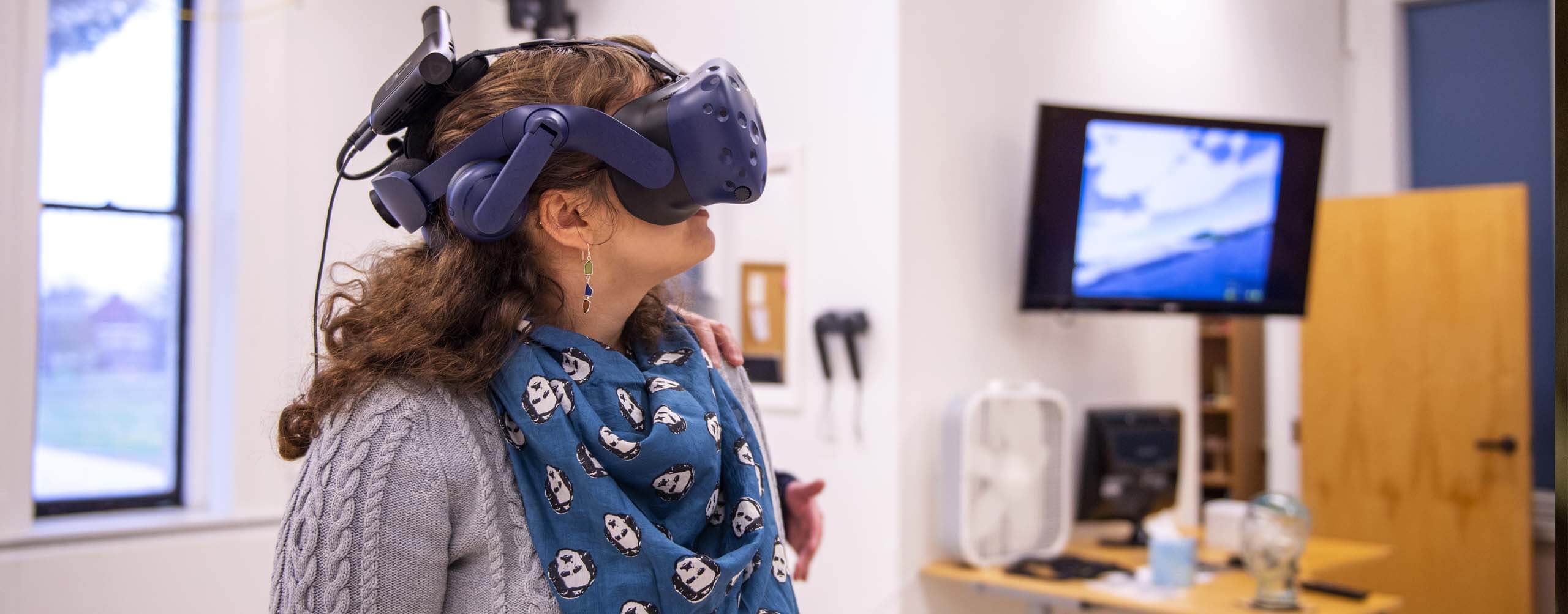 Computer Science student wearing tech goggles in a lab