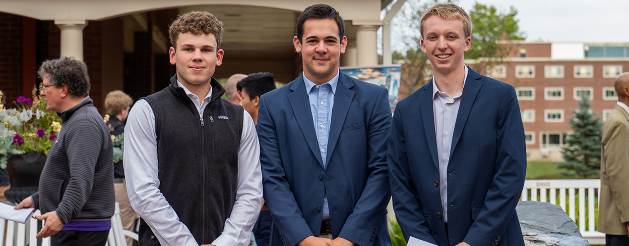 Three Business Management students smiling for a picture