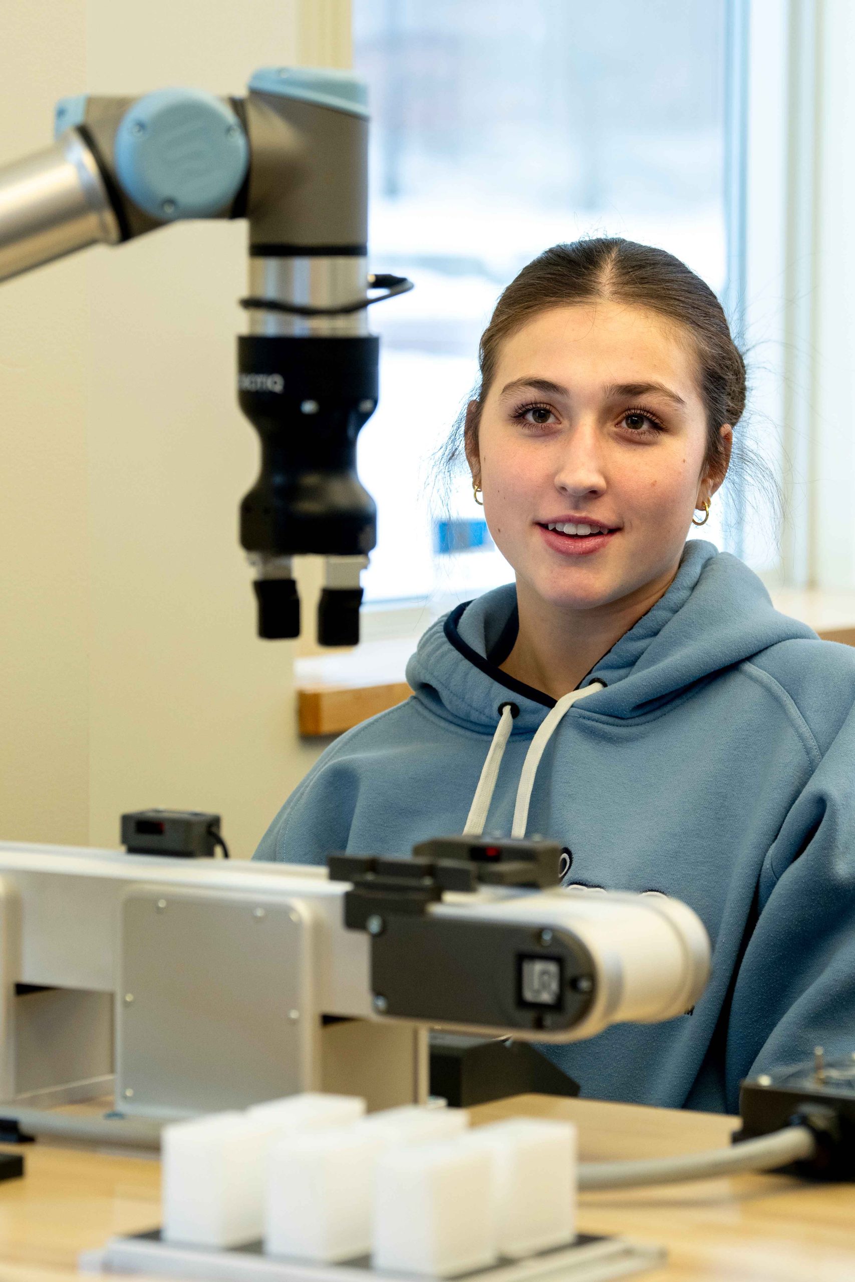 Computer Engineering student working with a machine
