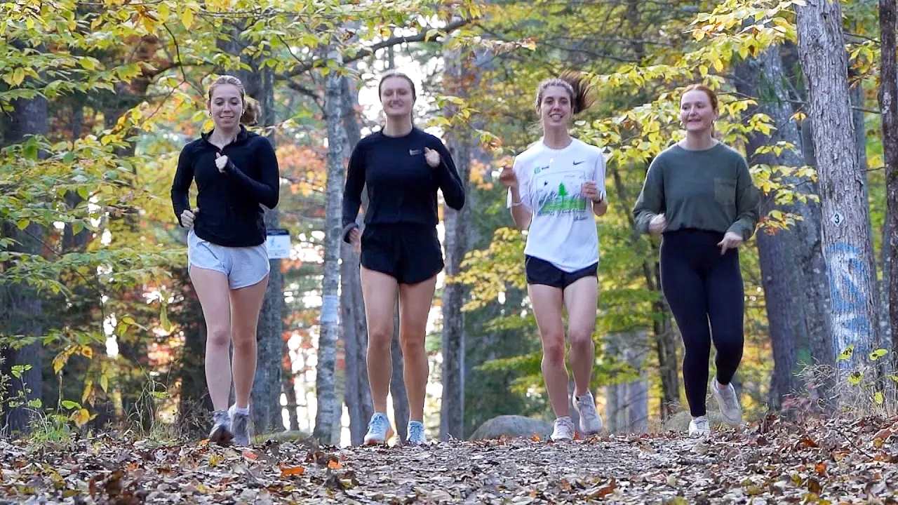 A photo of four people jogging on the trails on UMaine's campus