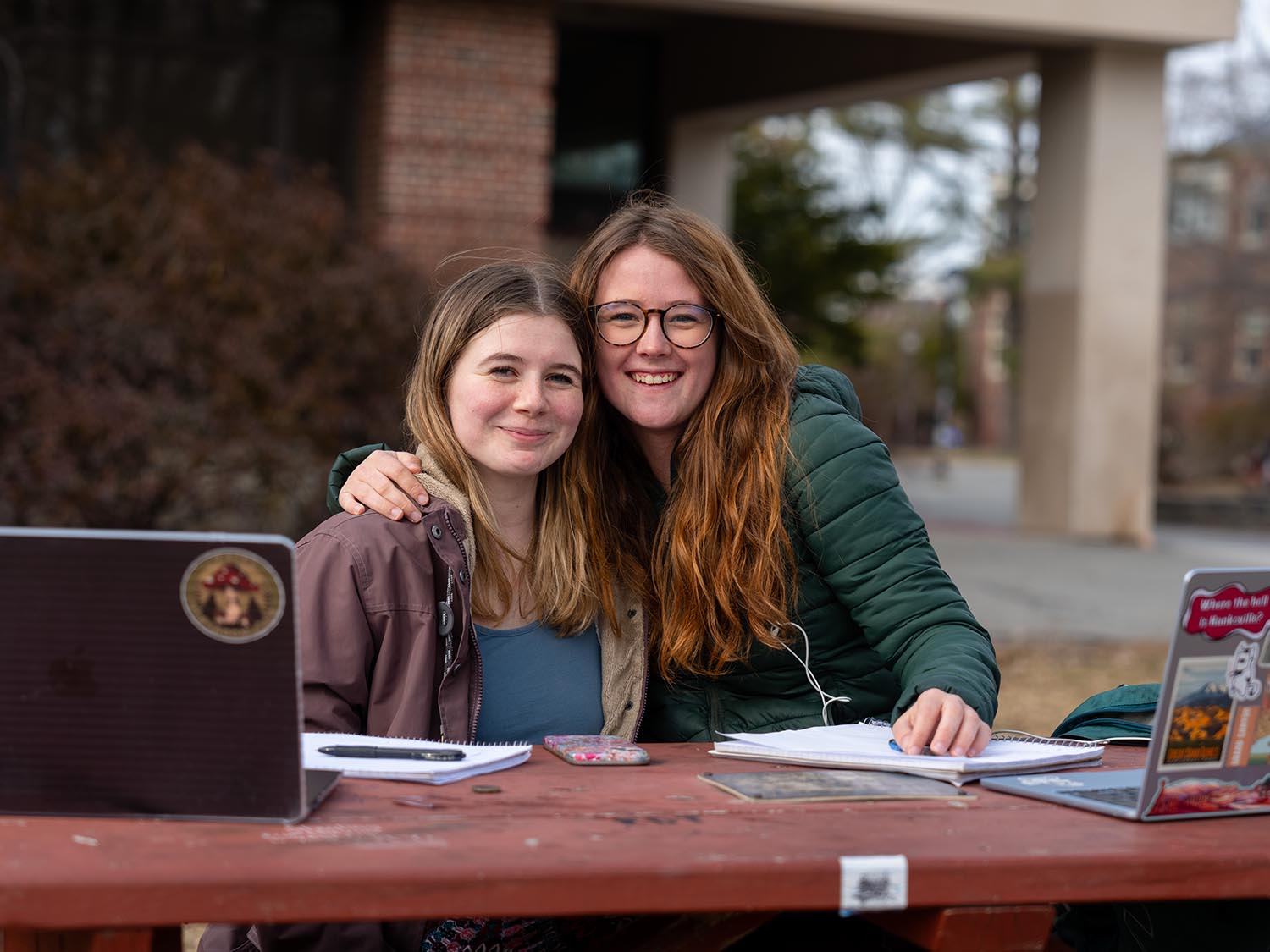 A photo of two people sitting at picnic table
