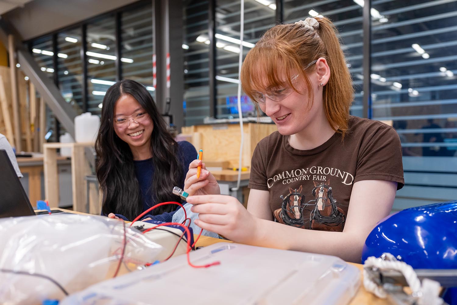 A photo of two students working on a project in an engineering lab