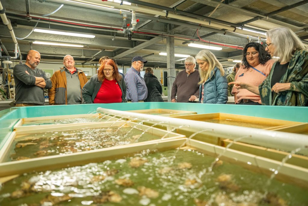 photo of a tour group at the down east institute being shown around the facility