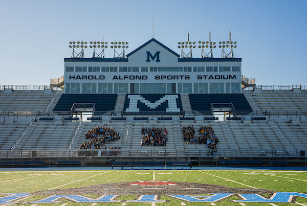 photo of people on the alfond stadium bleachers standing in shape of number 24