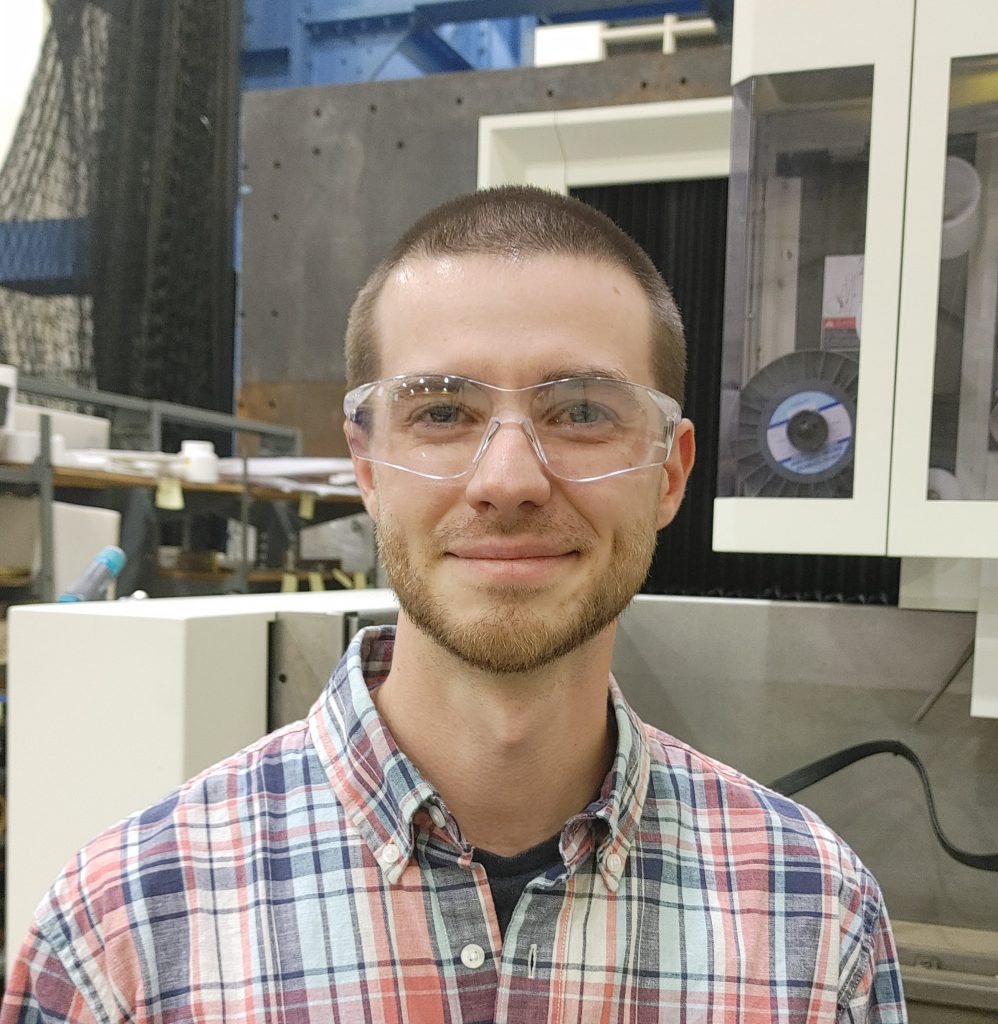 Profile picture of Dorian Reynolds facing the camera, shown from the shoulders up with a neutral background.