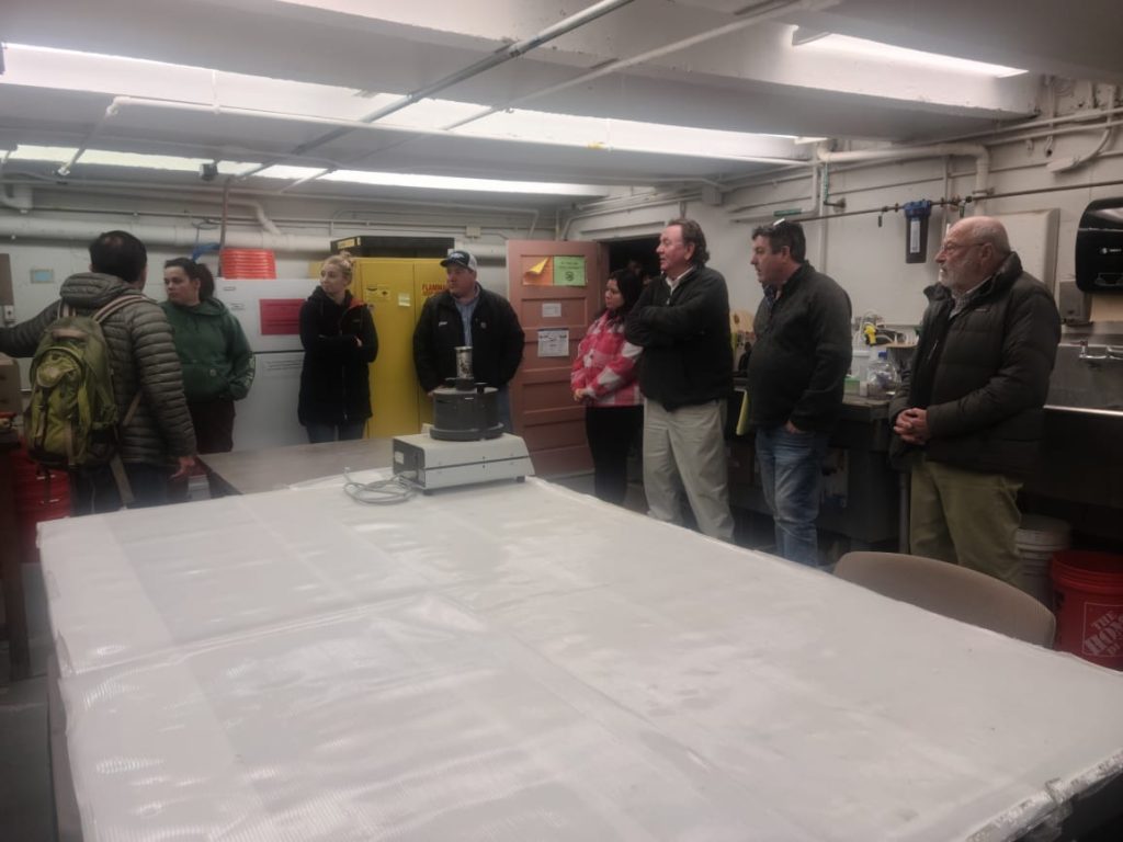 A photo of Dr. Romero showing our guests around his lab