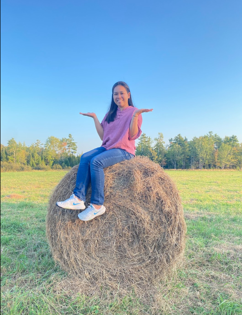 Photo of Jonalyn Sandro on a hay bale