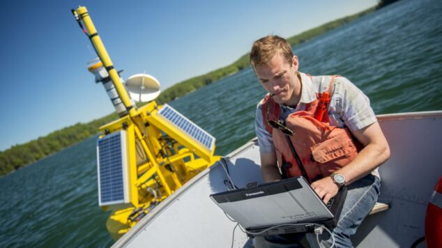 Matt with a laptop on a boat