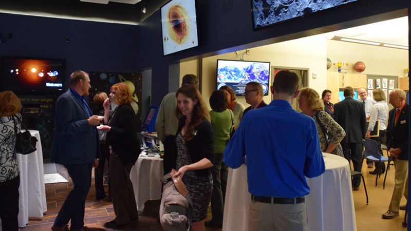 A photo of a group of people at an astronomy center party