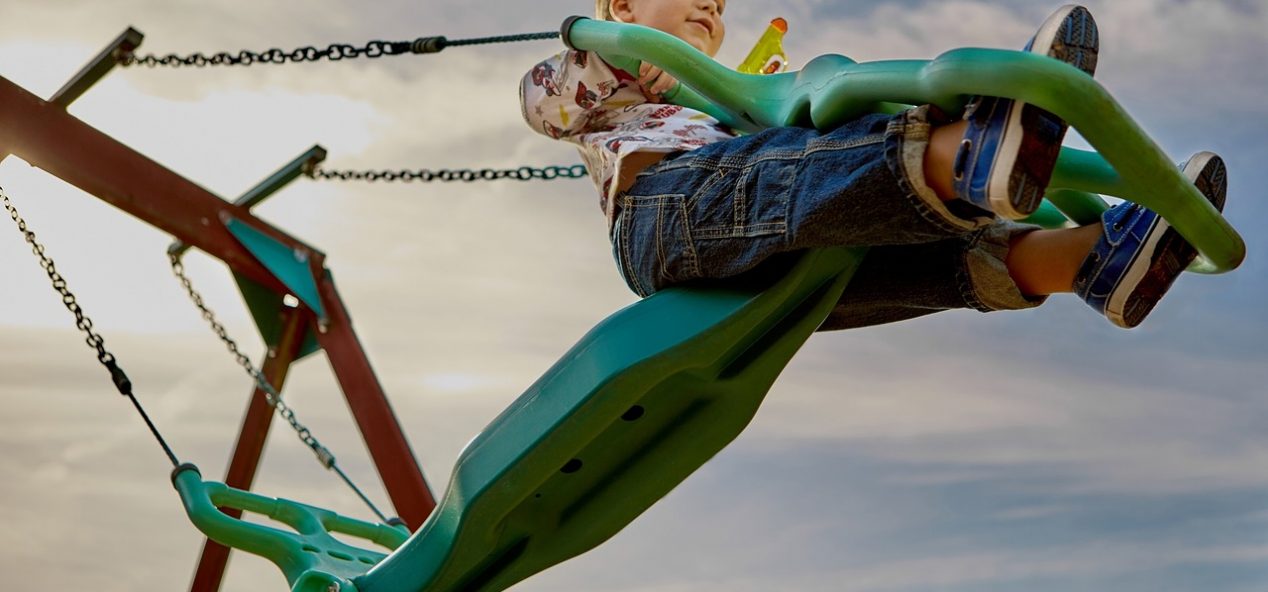 young child swinging