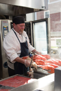 UMaine Dining employee removes freshly cooked Maine lobster