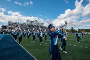 UMaine Marching Band performs crossing the football field at Alfond Stadium
