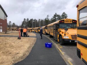 A photo of school buses outside a school in Maine where meals were being handed out to families of students during the COVID-19 pandemic.