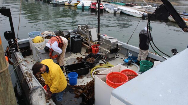 Students working on the back deck of a fishing boat