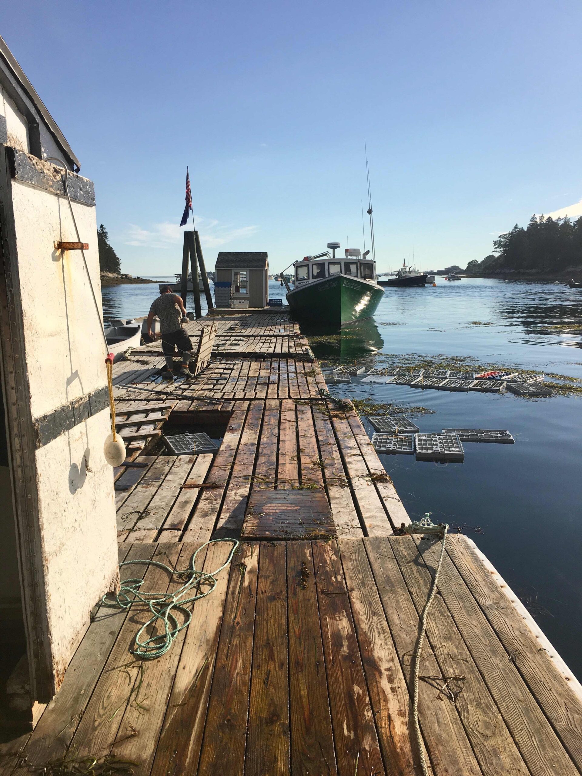 Lobster boat tide up to floating dock with crates