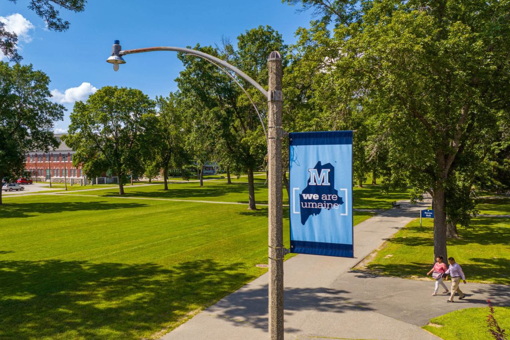 A photo of a pole banner on UMaine's campus