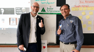 Dr. Jason Harkins and Dr. Pank Agrrawal volunteer with Junior Achievement of Maine