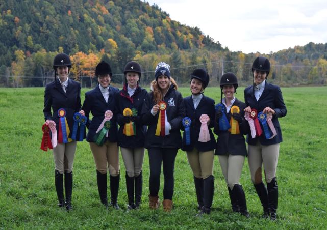 Equestrian team members pose with their award ribbons