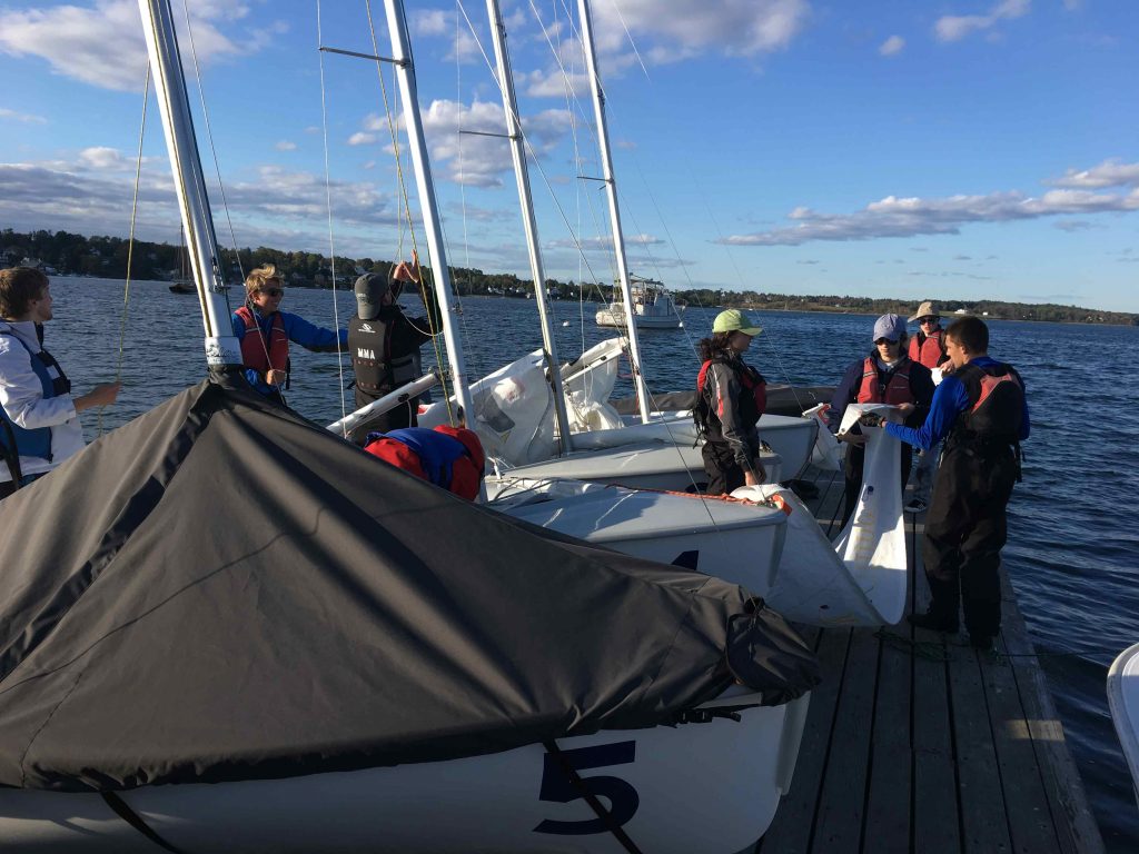 The UMaine Sailing team on a sailboat