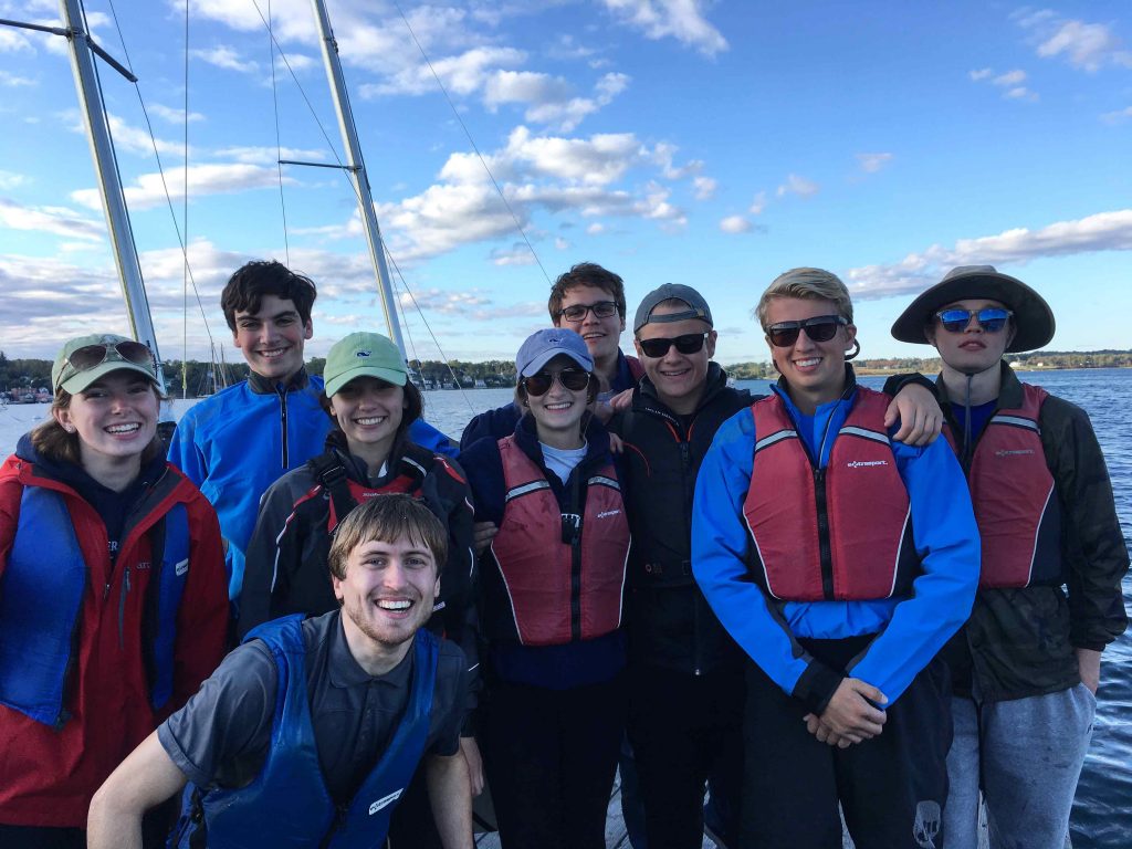 A group photo of the UMaine Sailing team on the water