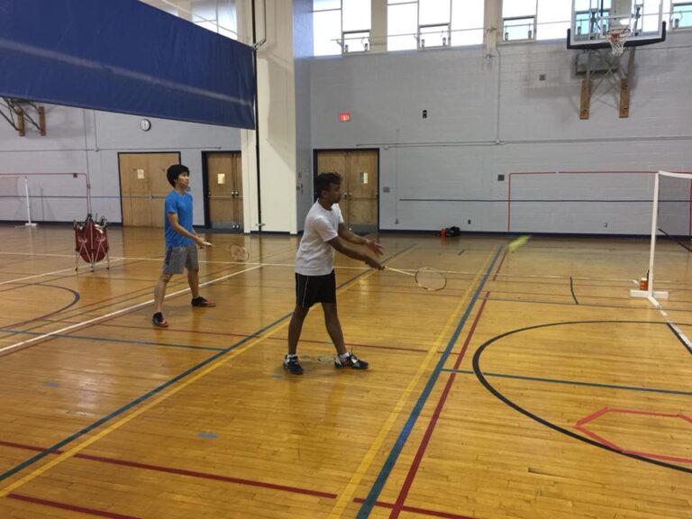 Students playing badminton inside the recreation center.