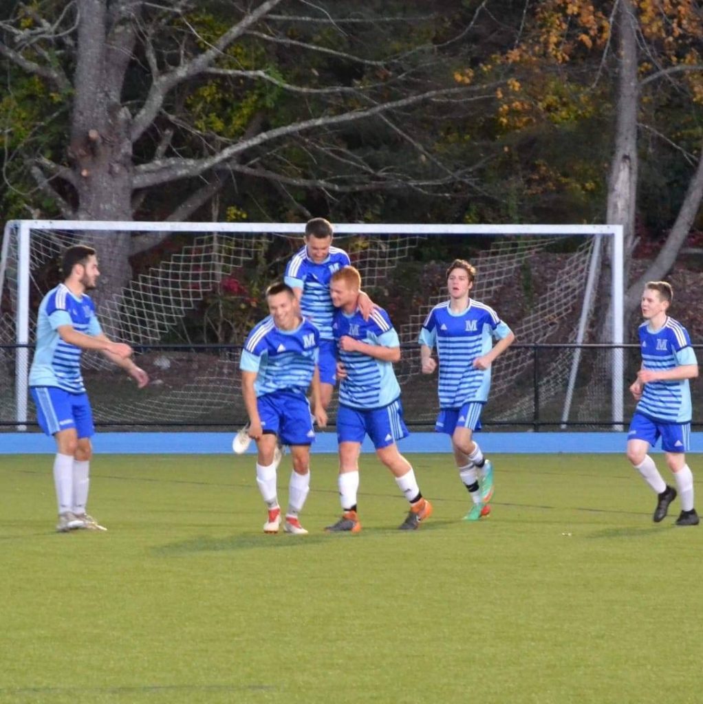 The Men's Soccer Club playing on the field