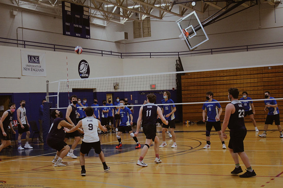 The Men's Volleball team playing on the indoor court