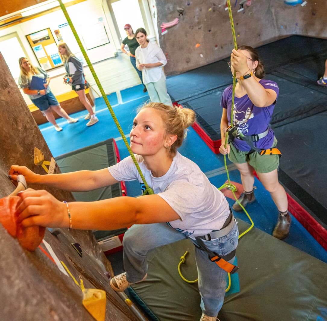 A photo of a person rock climbing at the Maine Bound Adventure Center