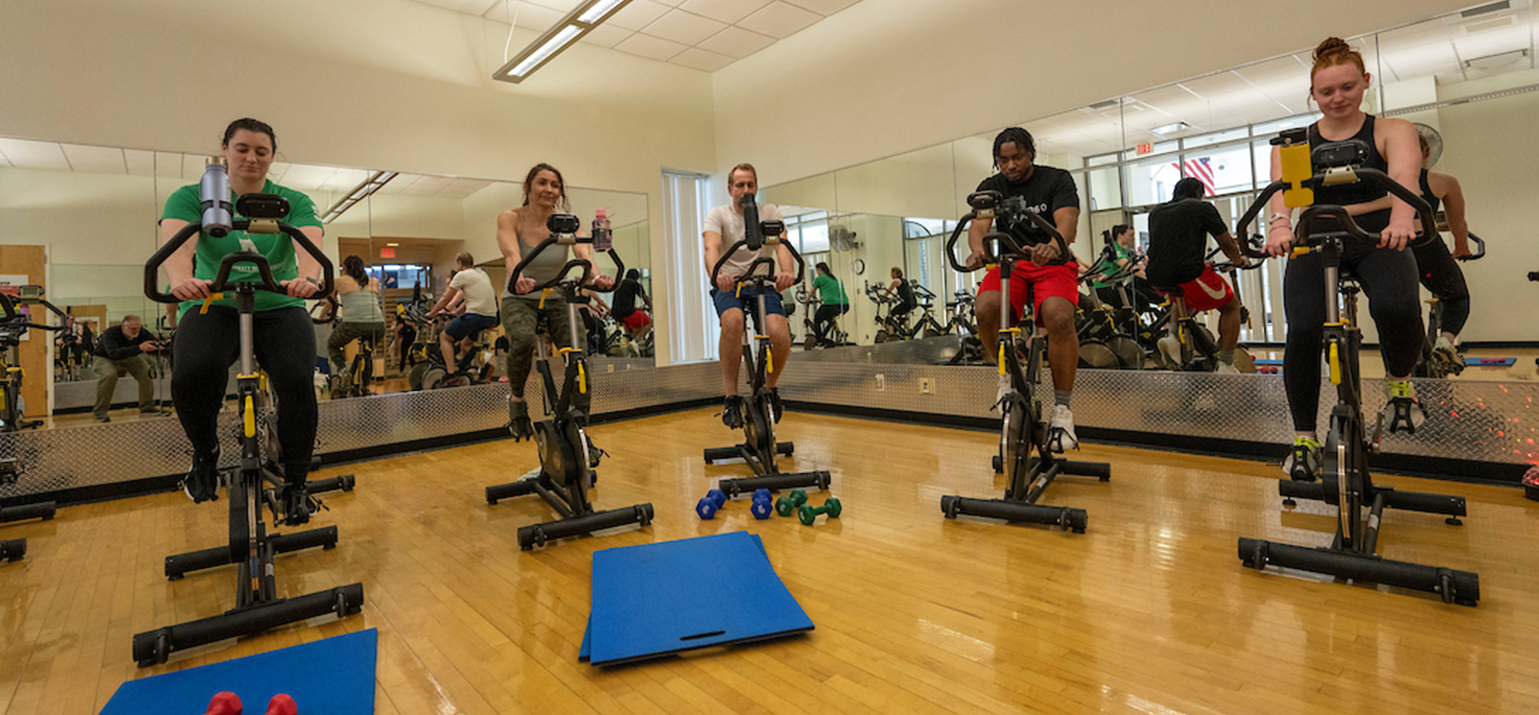 A photo of a group of spin cyclists