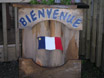 photo of window box with acadian flag and word bienvenue
