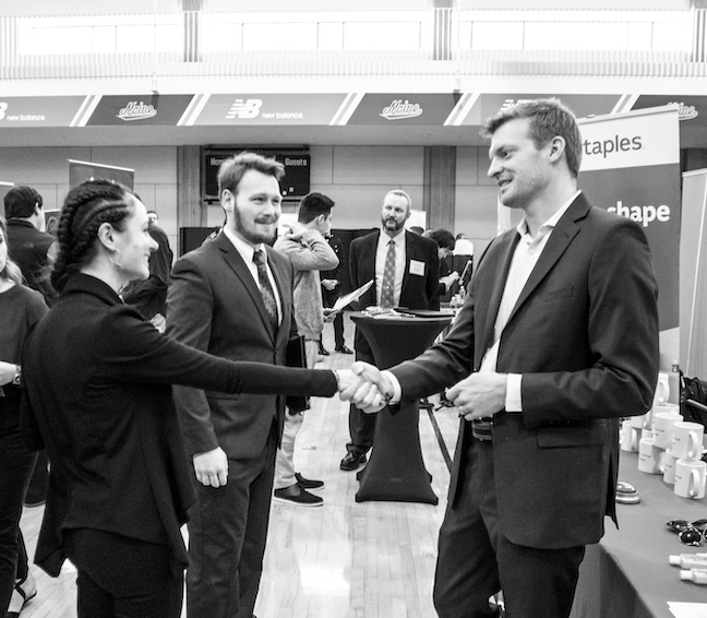 Picture from the job fair. A few meeting meeting and shaking hands.