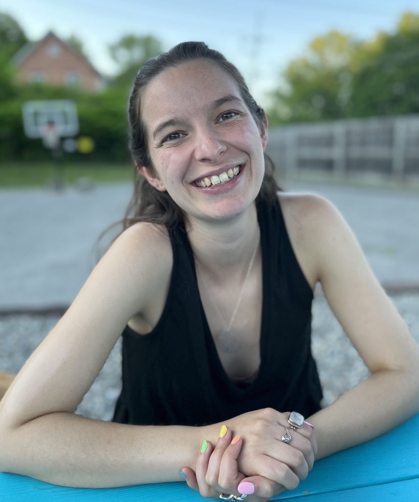 Headshot of Eleanor Schuttenberg with her hands held on the table.