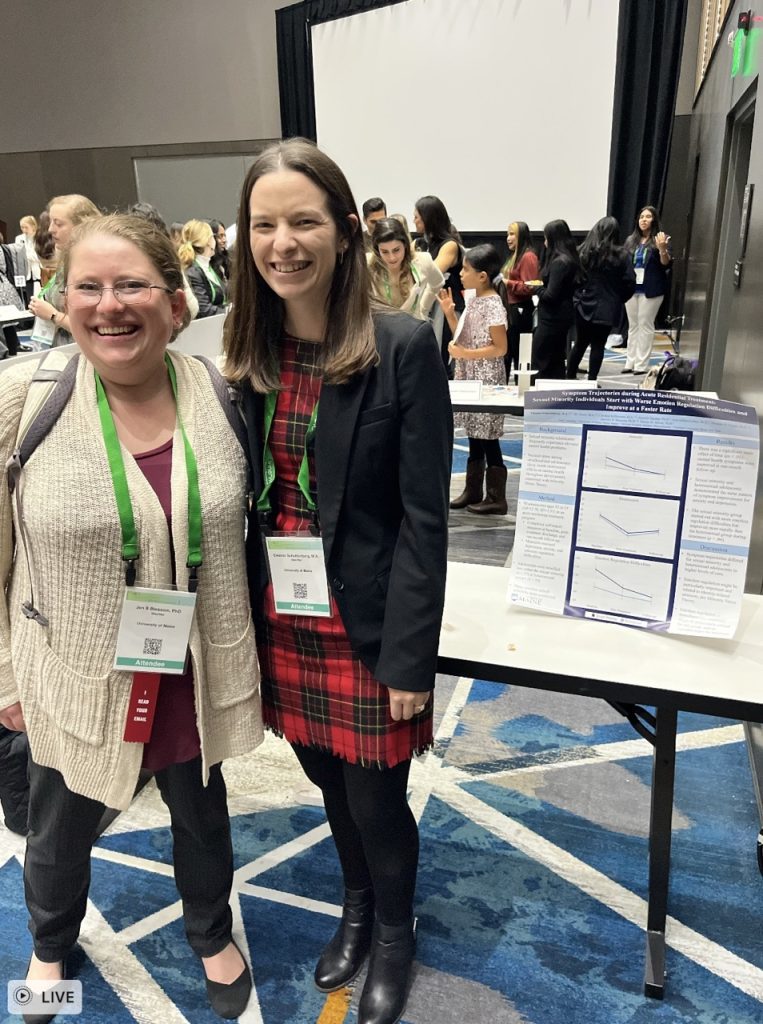 Dr. Blossom and Eleanor Schuttenberg standing with a poster at the ABCT conferece