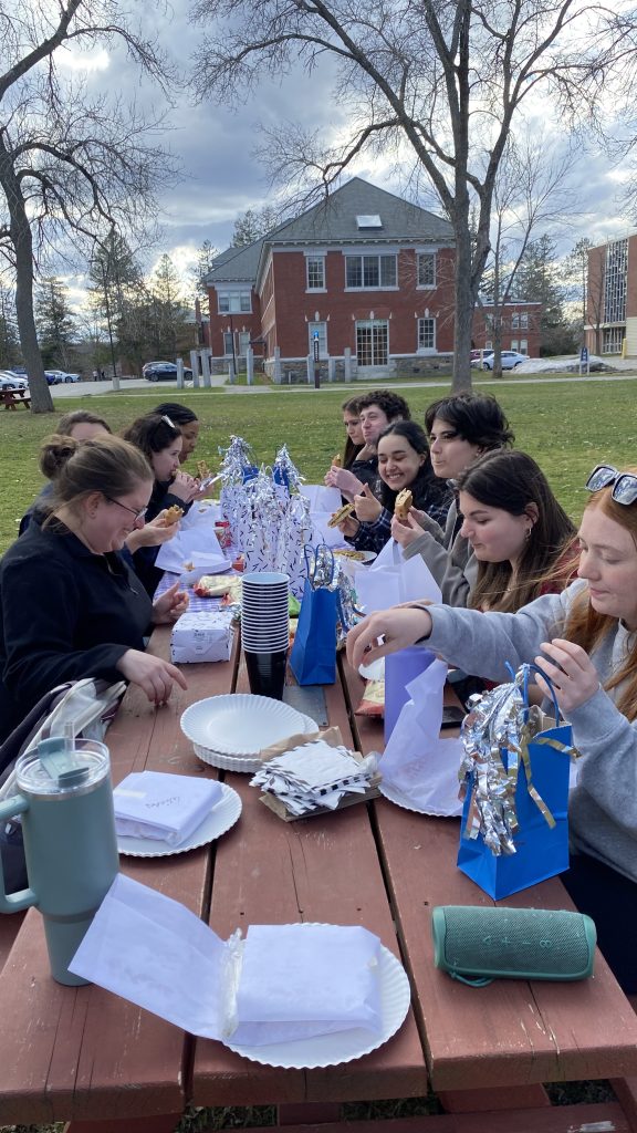 Members of the C-Cap lab eating food at the end of year picnic