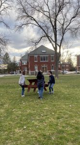 Members of the C-Cap lab moving a picnic table