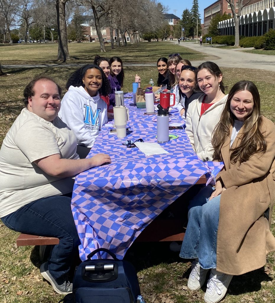 C-CAP Lab members sitting around a picnic table