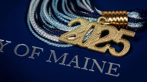 An image of a 2025 tassel and a diploma holder