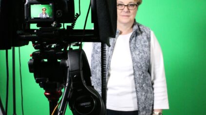 Faculty member in front of green screen