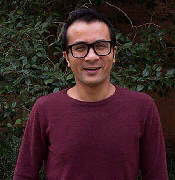 Headshot of professor Anup in a maroon sweater and glasses