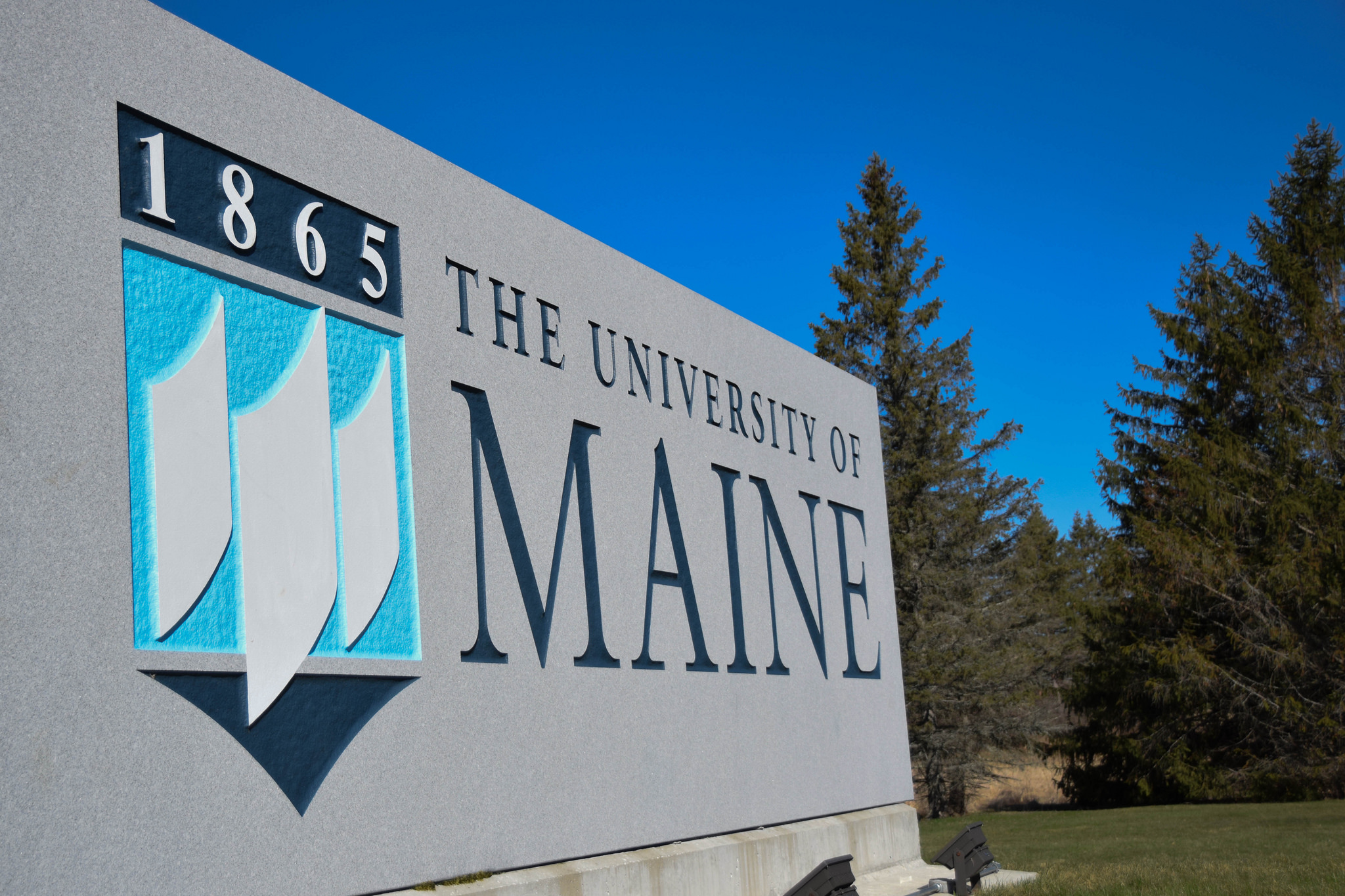 UMaine entrance sign. Large granite with University of Maine embossed in dark and light blues