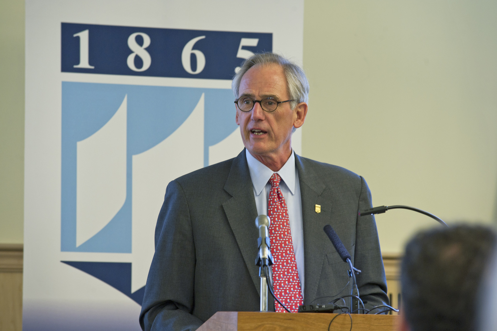 A photograph of Adm. Gregory Johnson giving a talk