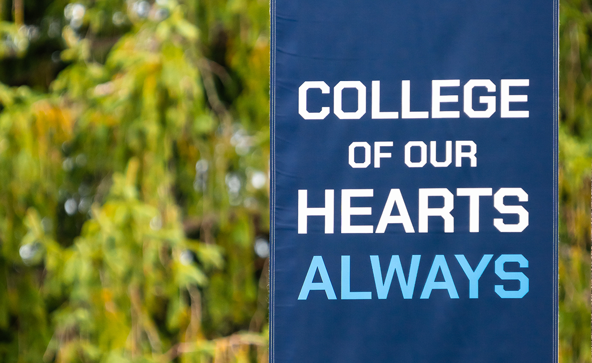 A photo of a sign that says "College of our hearts always"