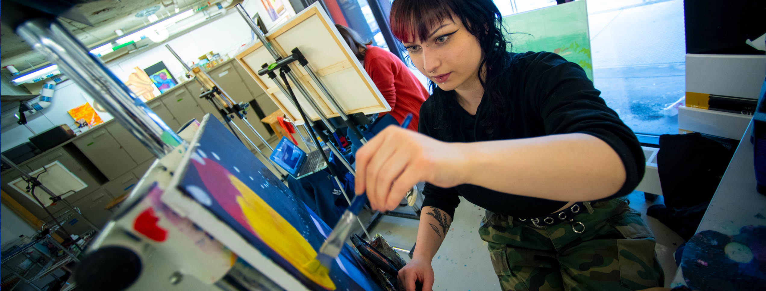 A photo of a student painting in a studio class