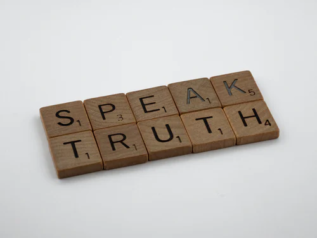ID: Scrabbles that Says "SPEAK TRUTH"