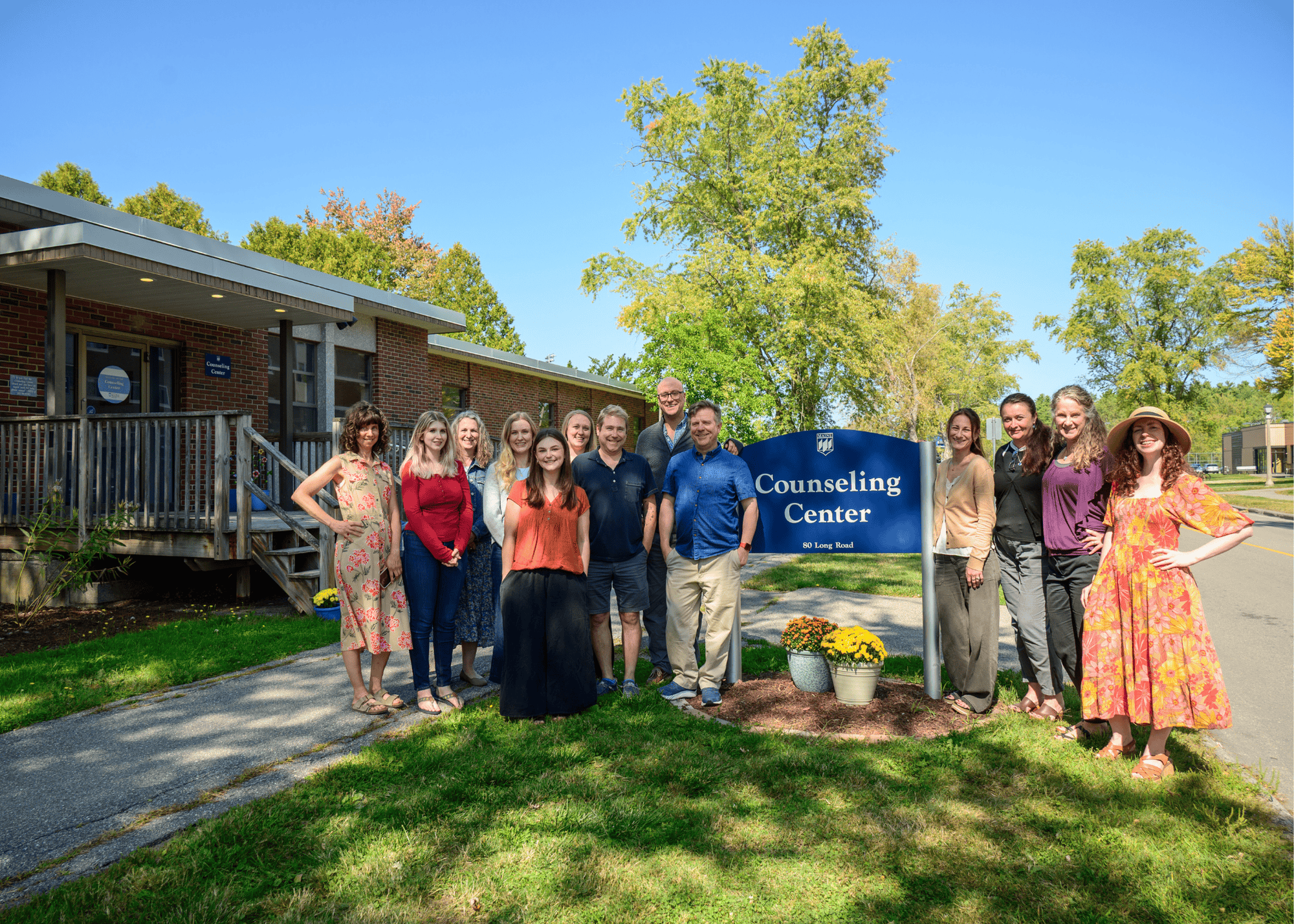 Counseling center staff of 2025 standing in front of counseling center sign and building