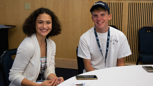 two students sitting at table at Early College orientation